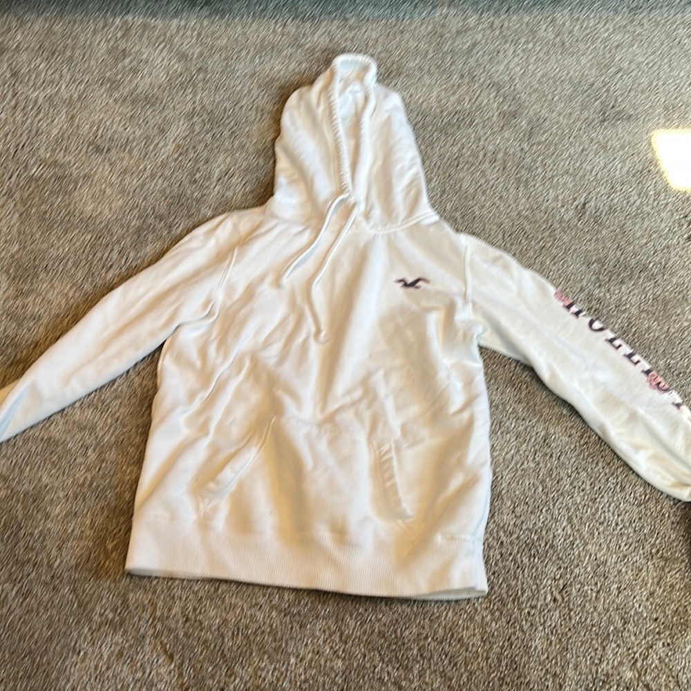 White with roses on the left arm the Hollister sweatshirt
